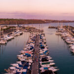 Amazing panoramic sunset view of Gran Canaria over many luxury yachts docked by the pier